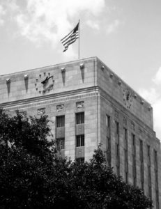 Closeup of Houston City Hall. The bobcat head sculptures can be seen on either side of the clocks (Creative Commons license attribution: photo courtesy Patrick Farrell)